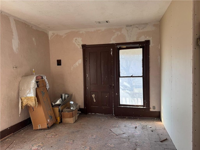 empty room with visible vents and a textured ceiling