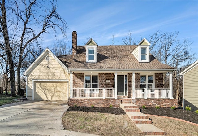 cape cod house featuring brick siding, a shingled roof, a porch, concrete driveway, and a garage