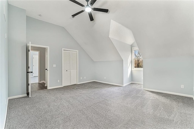 additional living space featuring lofted ceiling, baseboards, carpet floors, and ceiling fan