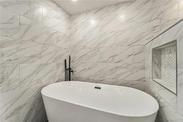 bathroom with a soaking tub and tile walls