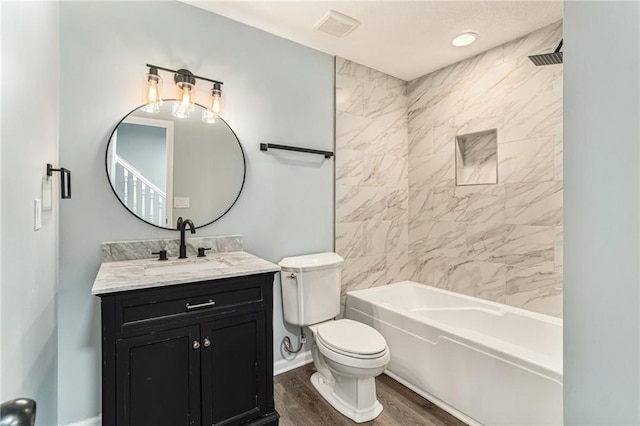 full bath featuring visible vents, toilet, wood finished floors, bathtub / shower combination, and vanity