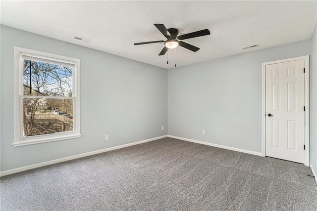 empty room with baseboards, carpet floors, a textured ceiling, and a ceiling fan