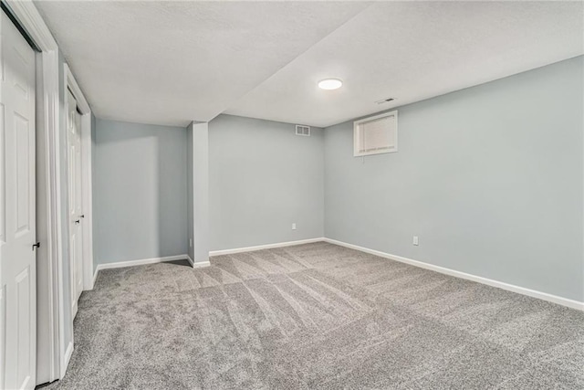 unfurnished bedroom with visible vents, baseboards, carpet, and a textured ceiling