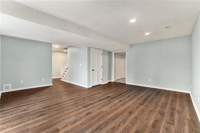 interior space with visible vents, dark wood-type flooring, baseboards, stairway, and recessed lighting