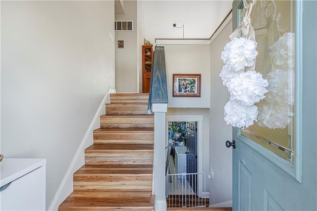 staircase featuring visible vents and baseboards