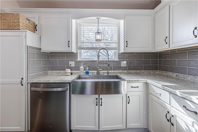 kitchen featuring backsplash, dishwasher, white cabinets, and a sink