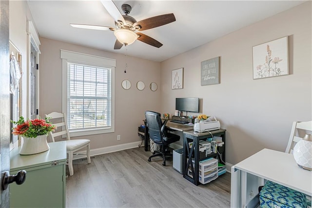 office space featuring light wood-style floors, baseboards, and ceiling fan