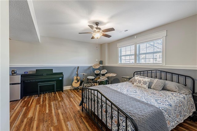 bedroom featuring baseboards, a ceiling fan, and wood finished floors