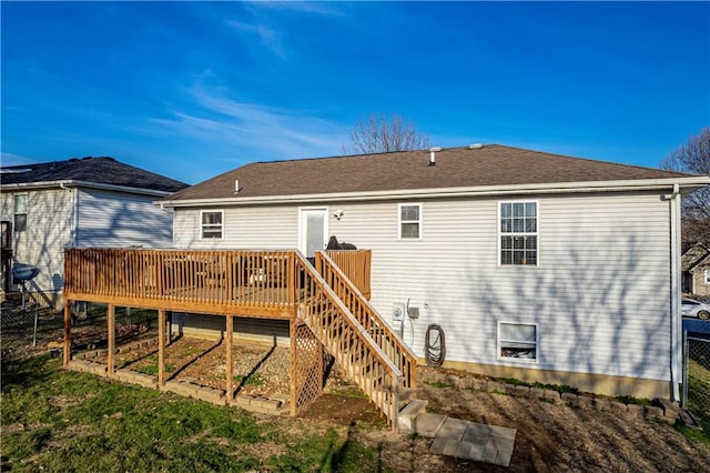 back of house featuring a wooden deck and fence