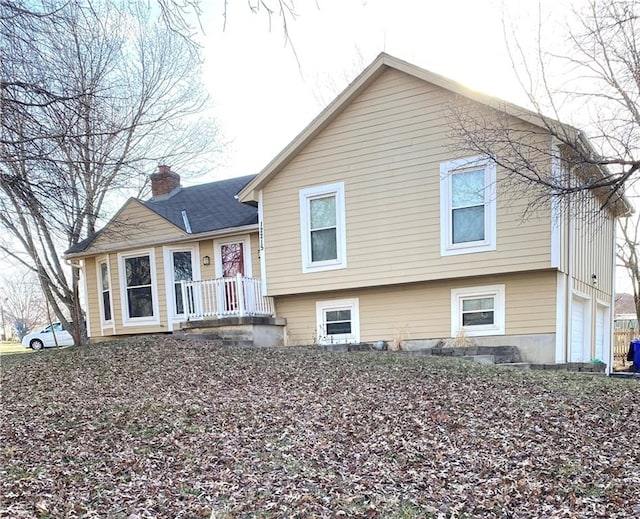 view of front of house featuring a garage and a chimney