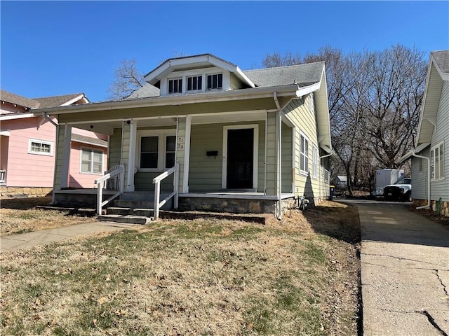 bungalow-style house with covered porch and driveway