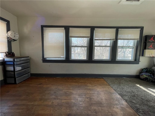 interior space featuring dark wood finished floors and baseboards