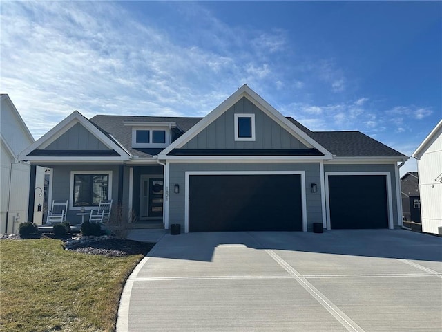 view of front facade featuring board and batten siding, a front lawn, a porch, concrete driveway, and a garage