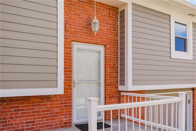 entrance to property with brick siding