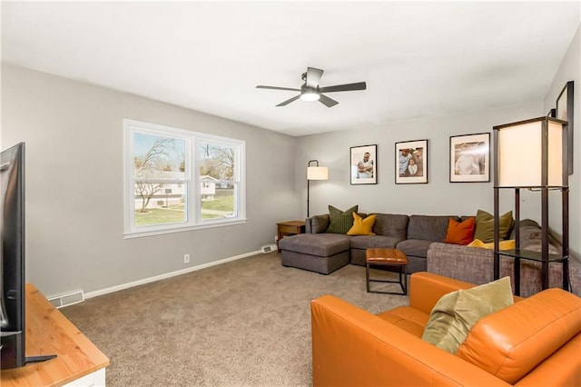 living area with visible vents, baseboards, and carpet floors