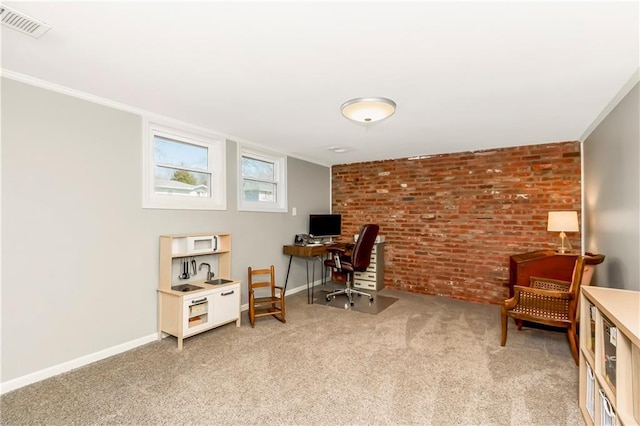 office space featuring visible vents, brick wall, baseboards, crown molding, and light colored carpet