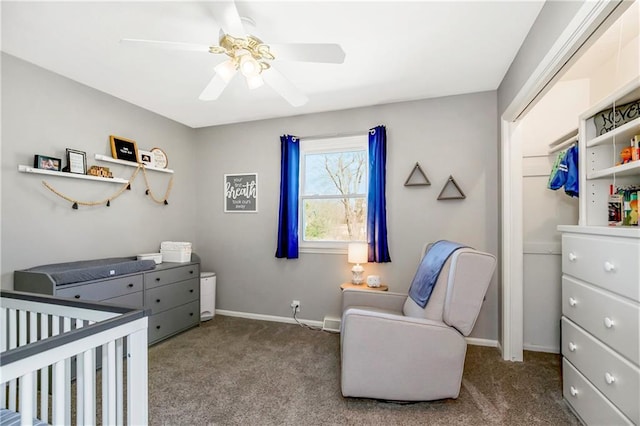 bedroom featuring a ceiling fan, a closet, a nursery area, carpet flooring, and baseboards