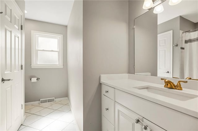 bathroom with tile patterned flooring, vanity, visible vents, and baseboards