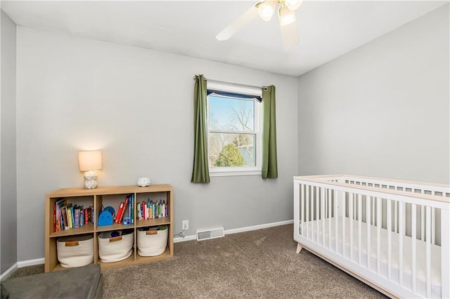 carpeted bedroom featuring a nursery area, visible vents, ceiling fan, and baseboards