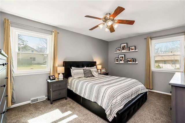 bedroom featuring carpet flooring, multiple windows, baseboards, and visible vents