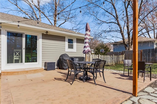 view of patio / terrace featuring outdoor dining area and fence