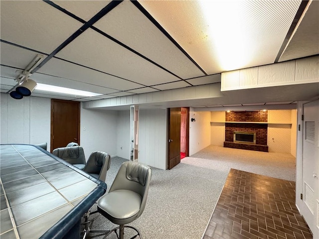 interior space with brick floor and a brick fireplace