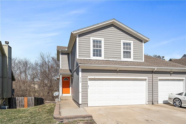 view of front facade featuring fence, driveway, and a shingled roof