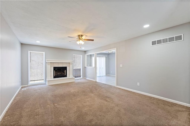 unfurnished living room with visible vents, baseboards, ceiling fan, and carpet floors