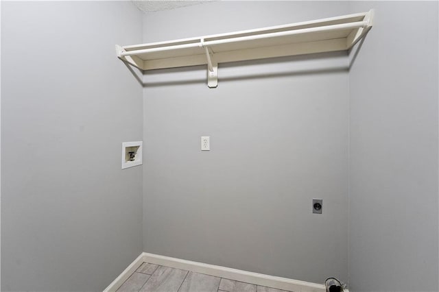 laundry area featuring baseboards, laundry area, hookup for a washing machine, light wood-style flooring, and hookup for an electric dryer