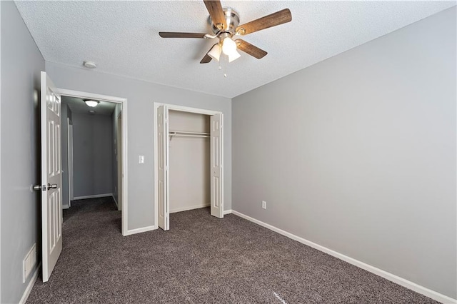 unfurnished bedroom featuring baseboards, visible vents, a closet, a textured ceiling, and dark colored carpet