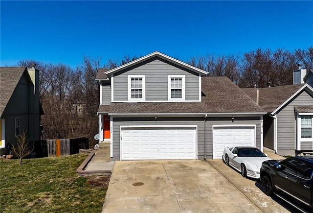 view of front facade with an attached garage, concrete driveway, a front lawn, and roof with shingles