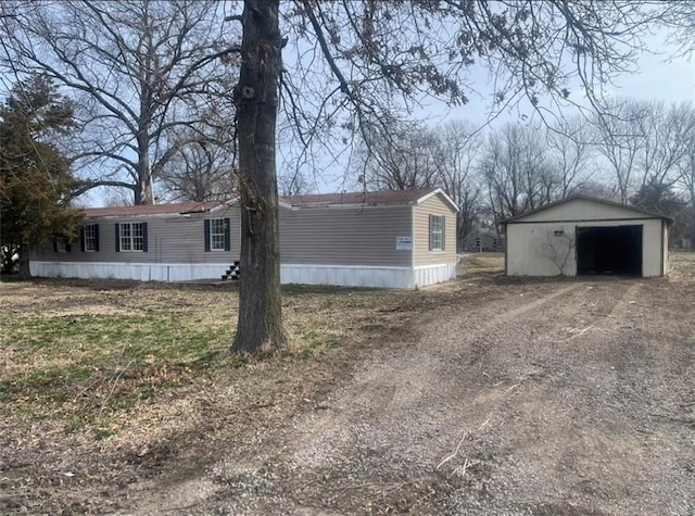 view of home's exterior featuring an outbuilding, driveway, and a detached garage
