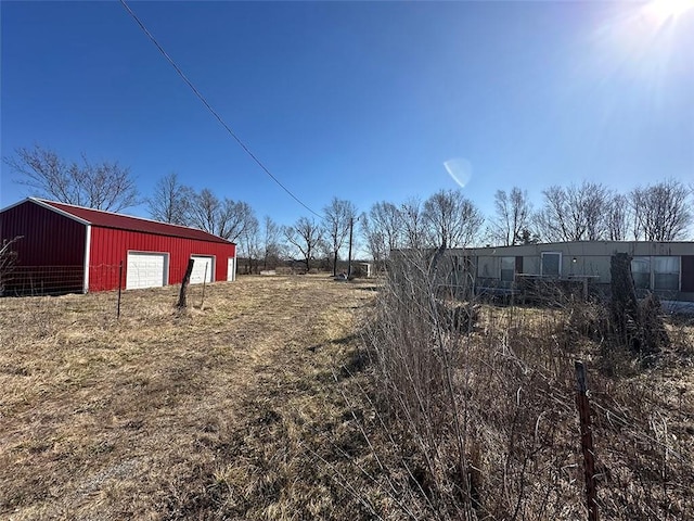 view of yard featuring an outbuilding and a garage