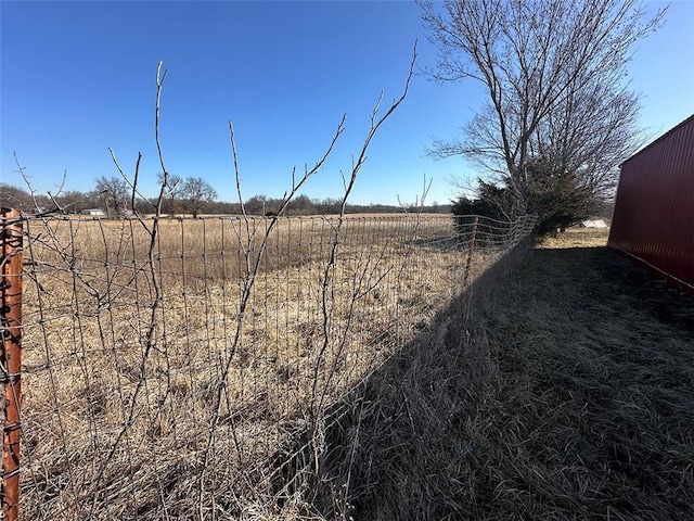 view of yard with an outbuilding and a rural view