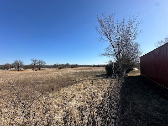 view of yard with an outbuilding and a rural view