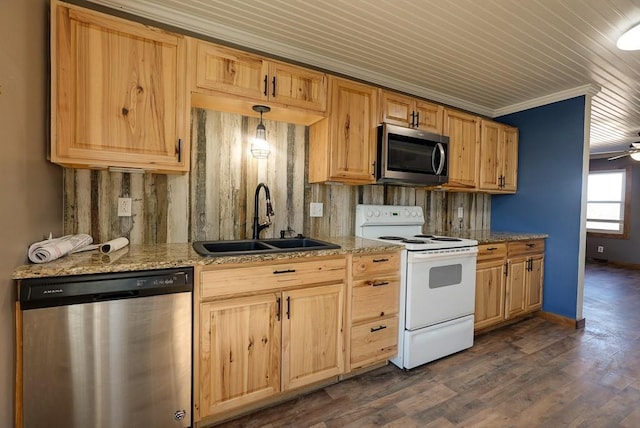 kitchen featuring a sink, light stone countertops, light brown cabinetry, appliances with stainless steel finishes, and dark wood-style flooring