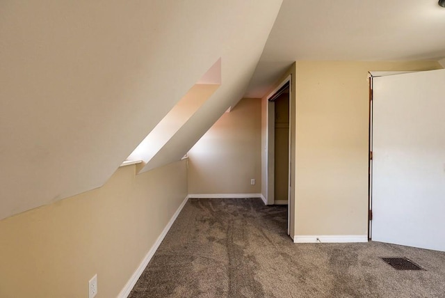 bonus room with visible vents, baseboards, lofted ceiling, and carpet