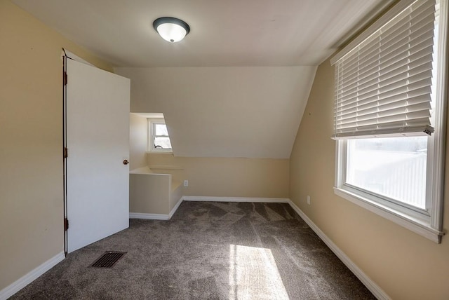 bonus room featuring visible vents, baseboards, lofted ceiling, and carpet