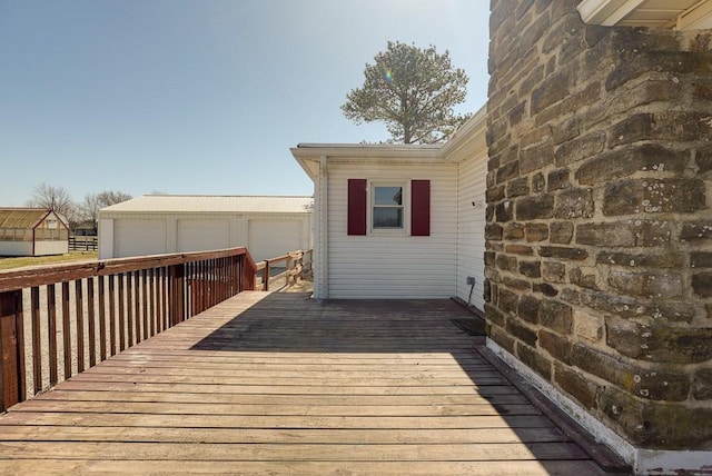 deck with a garage and an outdoor structure