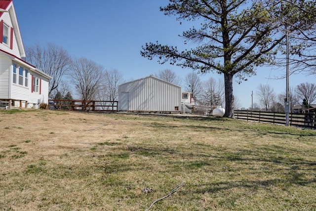 view of yard with an outdoor structure and fence