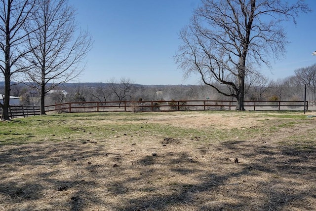 view of yard with a rural view and fence