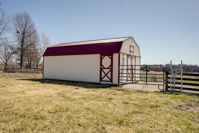 view of outdoor structure with an outbuilding and fence