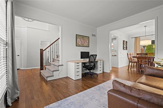 home office with visible vents, baseboards, dark wood-type flooring, a textured ceiling, and crown molding