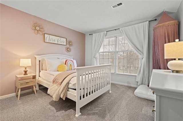 carpeted bedroom with visible vents and baseboards