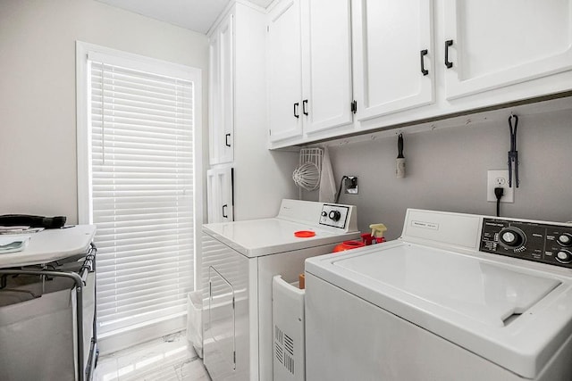 laundry area featuring washer and dryer and cabinet space