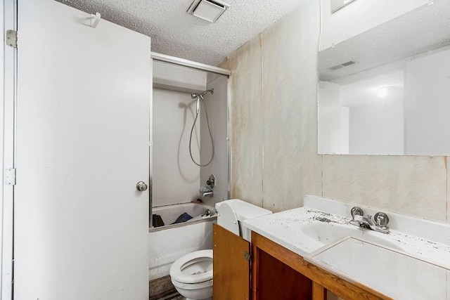 full bathroom with visible vents, a textured ceiling, washtub / shower combination, and toilet