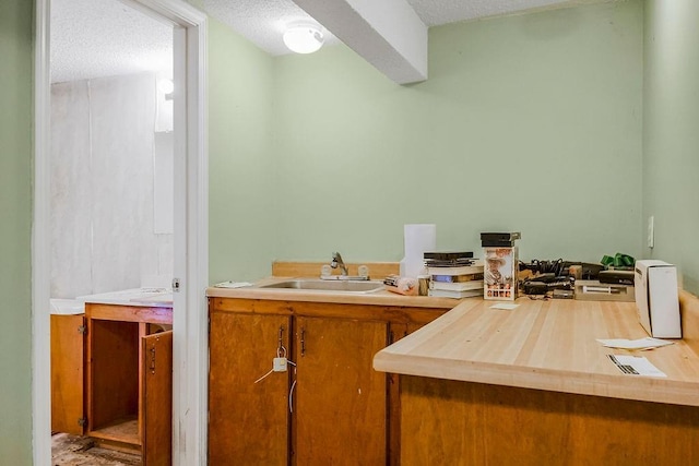 bathroom with a textured ceiling and a sink