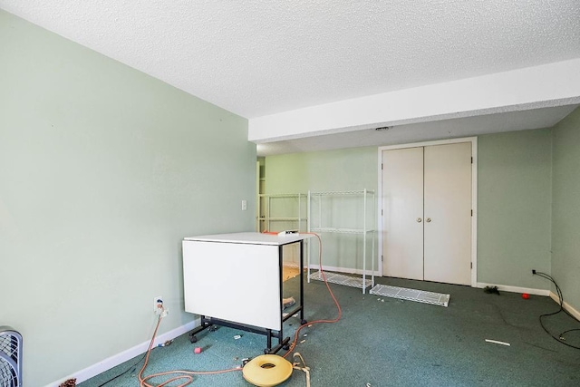 interior space with baseboards and a textured ceiling