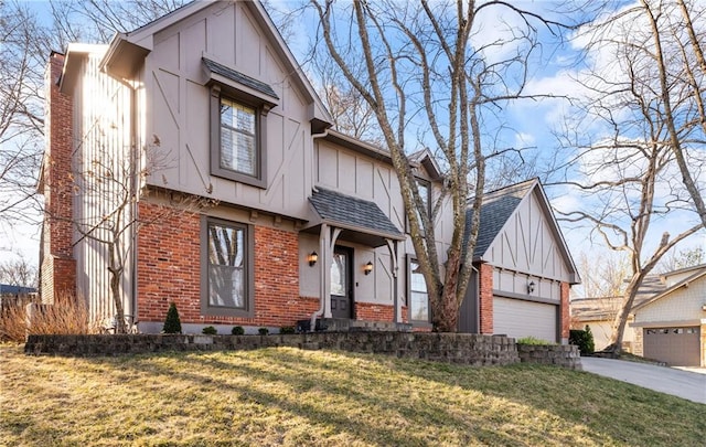 view of front of house with brick siding, board and batten siding, a front yard, a garage, and driveway