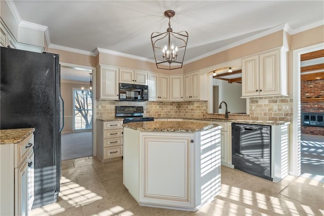 kitchen with black appliances, cream cabinetry, and a notable chandelier